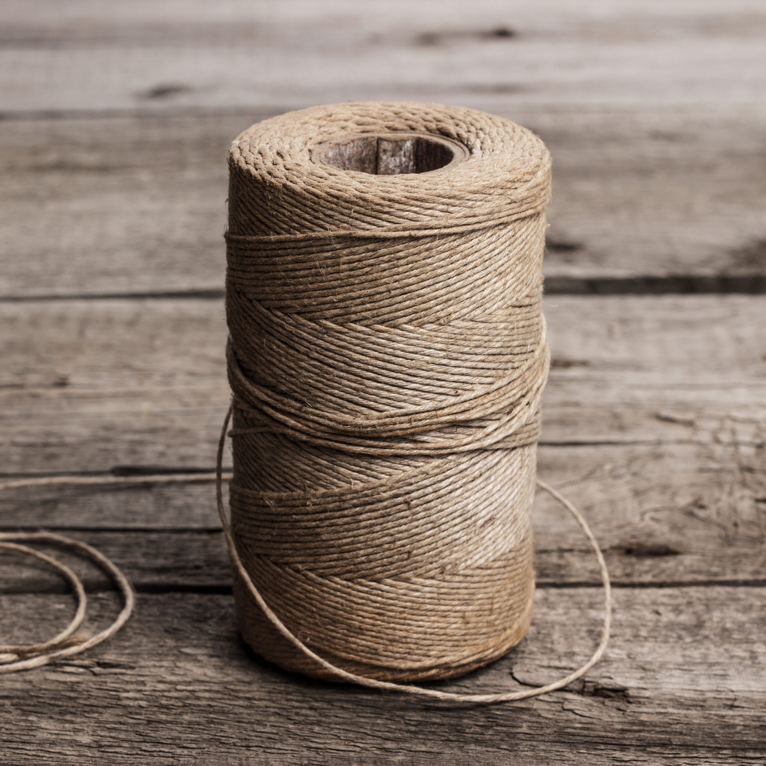 reel of durable thread on the wooden table